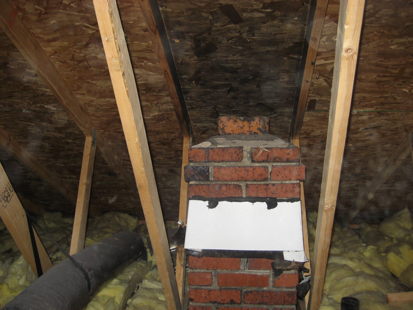 Pulling a permit doesn’t guarantee that everything is correct. The builder added a second story to this rambler, BUT, forgot to extend the chimney through the roof! The chimney terminates in the attic. Notice the blackened plywood from the gas furnace