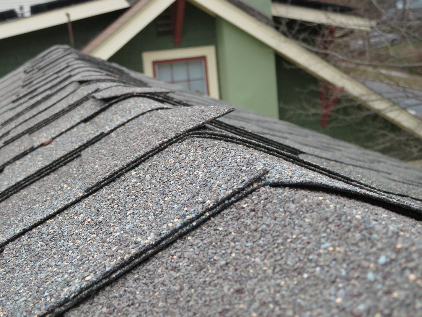 Improper-shingles-are-used-at-this-roof-ridge-notice-how-the-edges-are-stick-up