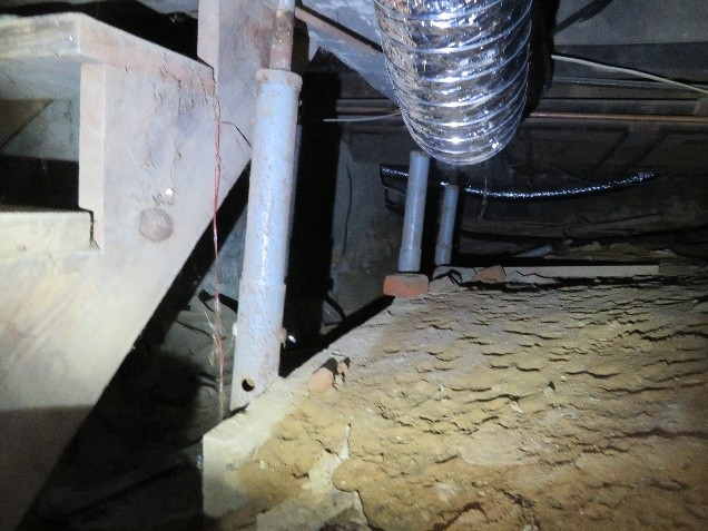  The structural posts in the crawl space are leaning, one already fell. THIS IS THE MAIN HOUSE BEAM SUPPORT! 