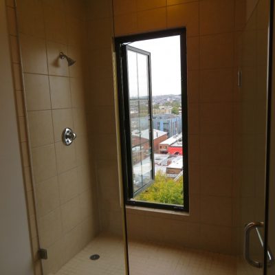 This bathroom window, very close to the slippery shower floor in a top level apartment opens completely out without any safety barrier.