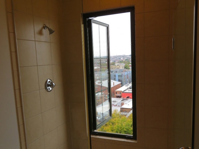 This-bathroom-window-very-close-to-the-slippery-shower-floor-in-a-top-level-apartment-opens-completely-out-without-any-safety-barrier.