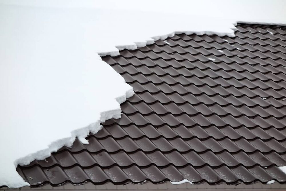 Install a snow guard or a snow fence to keep the snow from breaking off in chunks from your metal roof. 