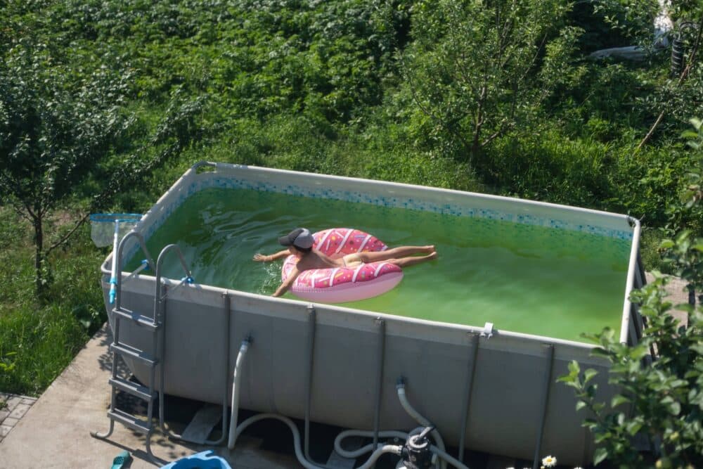 A pool that needs to be shocked and is green.