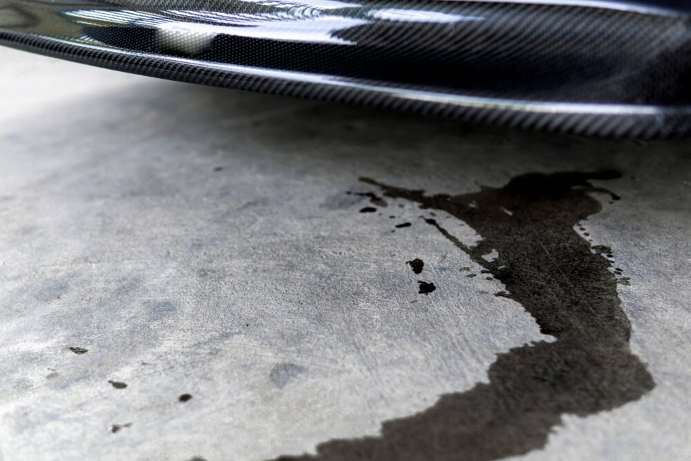 Oil stain on the driveway that needs to be wiped up before it sets.