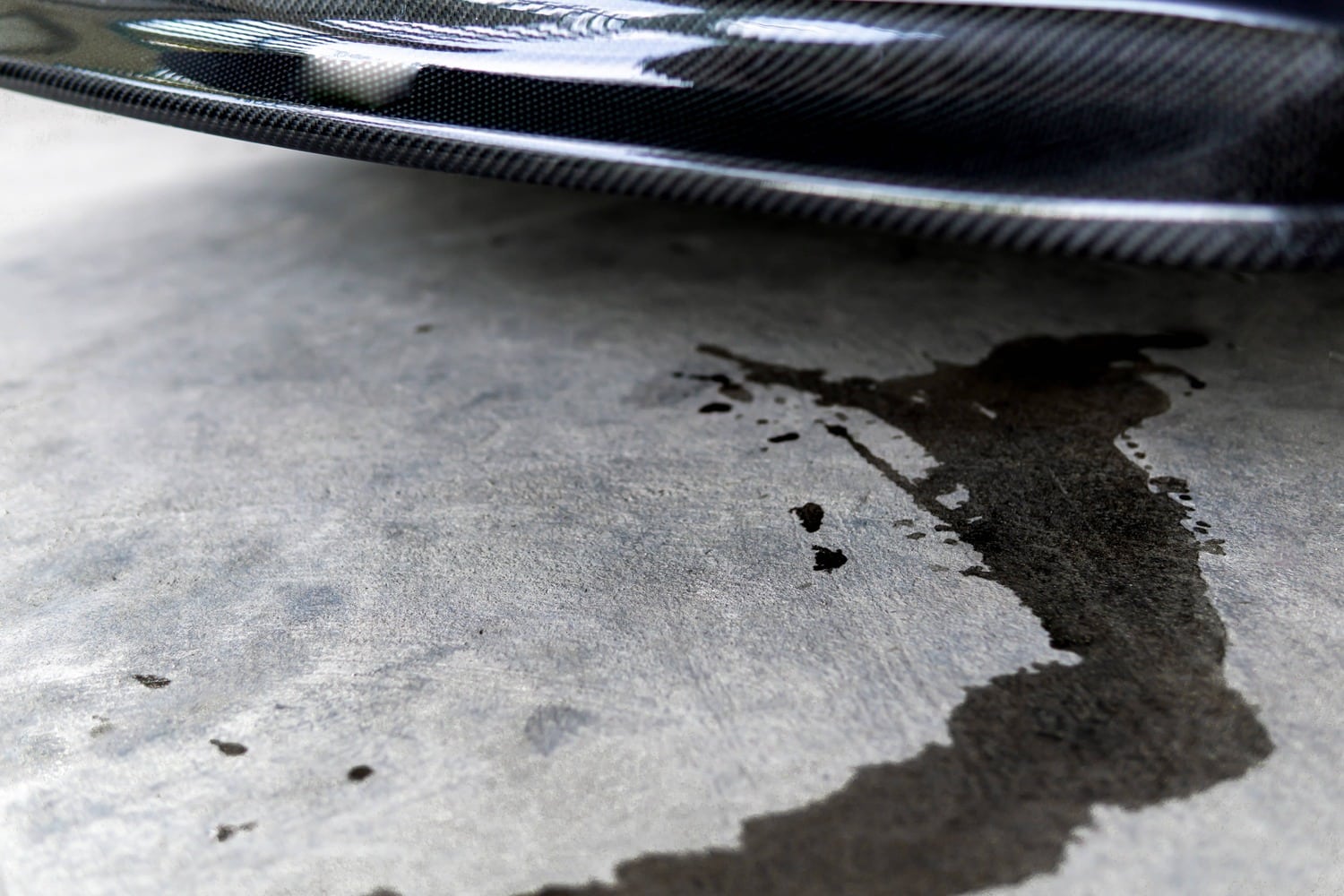 Oil stain on the driveway that needs to be wiped up before it sets.